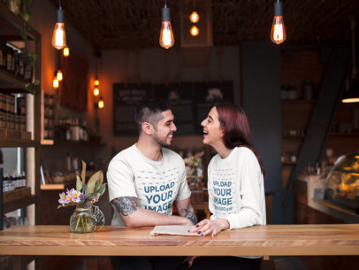 Happy Couple Wearing a T-Shirt and a Crewneck Sweater Mockup while on a Date in Valentine's Day