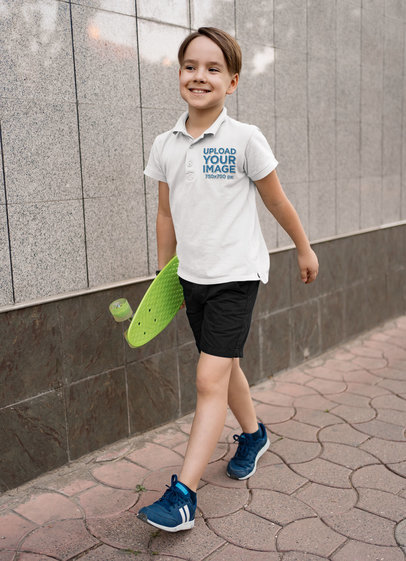 Polo Shirt Mockup of a Happy Boy Carrying a Small Skateboard