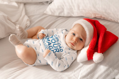 Heathered Onesie Mockup of a Baby With a Xmas Hat on a Bed m20523-r-el2