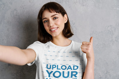 T-Shirt Mockup of a Woman Smiling Giving a Thumbs-Up Signal