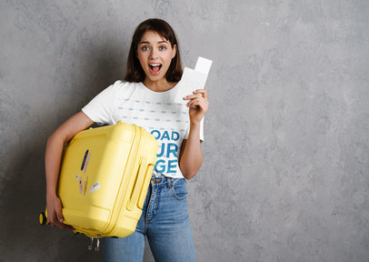 T-Shirt Mockup Featuring a Young Woman Holding a Suitcase and Airplane Tickets 
