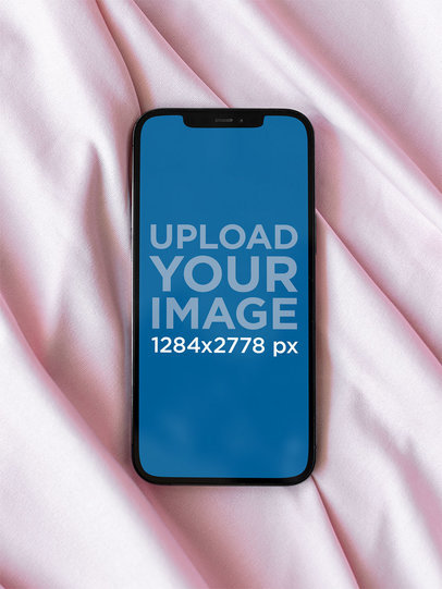 Mockup of an iPhone 12 Pro Max Placed on a Pink Cloth m21960