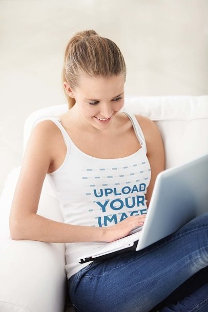 Tank Top Mockup of a Happy Woman Using Her Laptop at Home