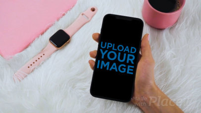 Video of a Woman Holding an iPhone 12 Pro Max in Her Hand