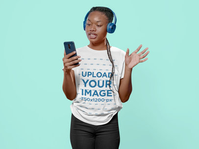 Round-Neck Tee Mockup of a Woman with Headphones Holding a Smartphone