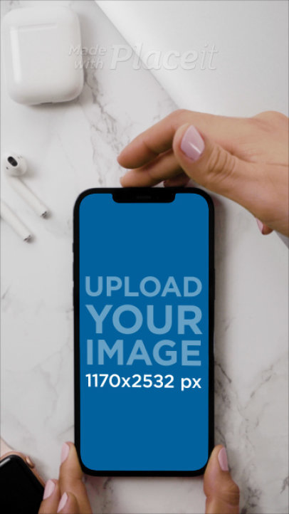 Video of an iPhone 12 Pro Max Placed over a Marble Surface Next to a Pair of Airpods 4748v