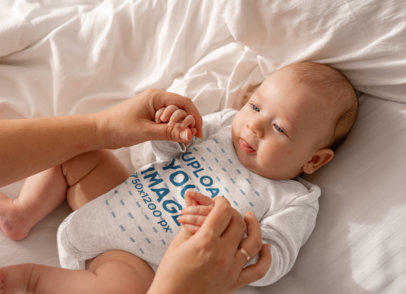 Long Sleeve Heathered Onesie Mockup Featuring a Baby Boy Holding His Mother's Hands