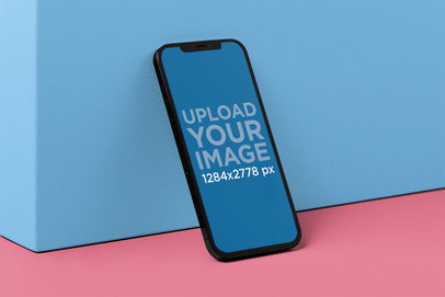 Mockup of an iPhone 12 Pro Max Leaning on a Colored Platform m21875
