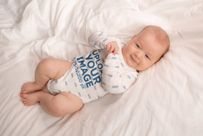 Mockup of a Long Sleeve Sublimated Onesie Featuring a Cute Smiling Baby Boy