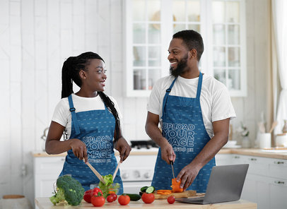 Apron Mockup Featuring a Happy Couple Cooking in a Kitchen