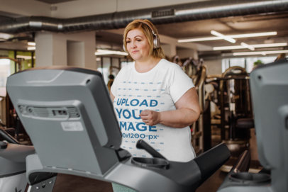 Mockup of a Woman Walking on a Treadmill While Wearing a Plus-Size Tee m21453-r-el2