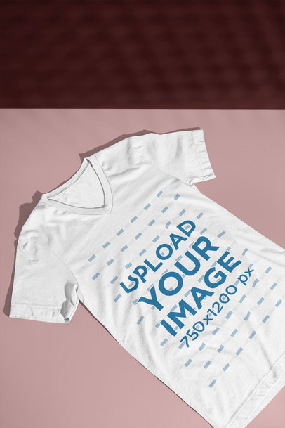 Basic Mockup of a Bella Canvas V-Neck T-Shirt Laying on a Colorful Surface