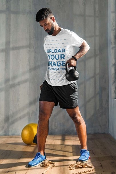 Heathered Tee Mockup of a Man Exercising with Kettlebells m19709-r-el2
