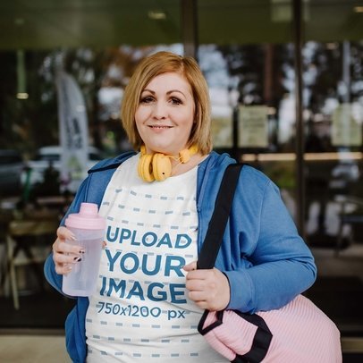 T-Shirt Mockup of a Happy Woman Holding a Bottle and her Gym Bag m21411-r-el2