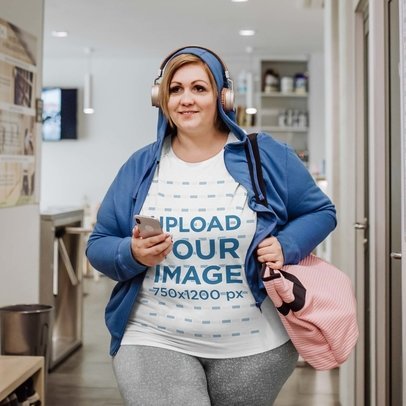 T-Shirt Mockup of a Woman Smiling and Walking with her Headphones On m21413-r-el2