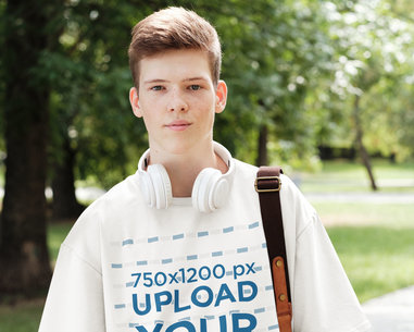 T-Shirt Mockup Featuring a College Student with Headphones Around His Neck