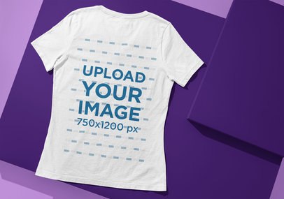 Back-View Mockup of a Bella Canvas T-Shirt Placed on a Colorful Surface