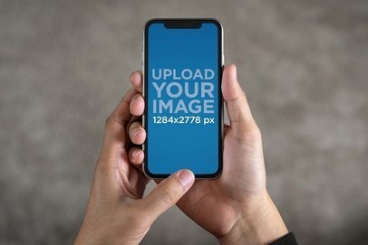 Mockup of a Man Using an iPhone 11 in Vertical Position