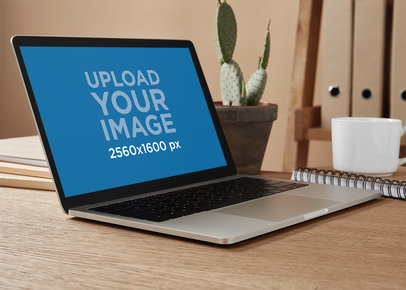 Mockup of a MacBook on a Desk with a Cactus