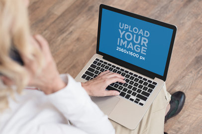 Mockup of a Woman Working with a MacBook on Her Lap