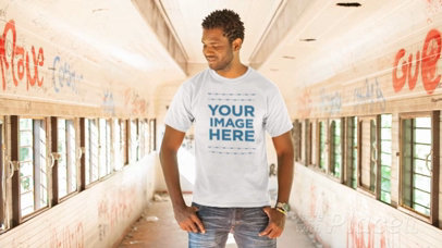 T-Shirt Video of a Young Man Standing in an Old Wagon
