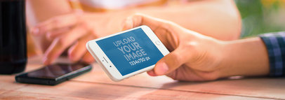  Wide Mockup of an iPhone 6 Held by a Man Hanging Out 