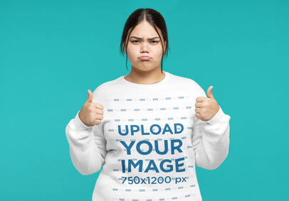 Sweatshirt Mockup Featuring a Sad Woman Posing With Her Thumbs Up