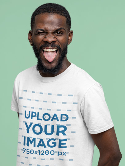 T-Shirt Mockup of a Man Doing an Irreverent Expression in a Studio