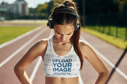 Sports Bra Mockup Featuring a Serious Woman with Headphones