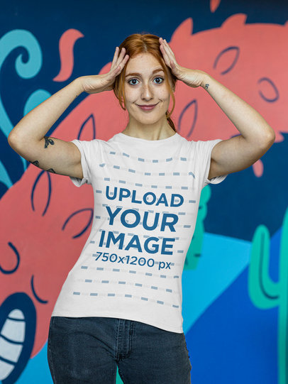 Tee Mockup of a Woman With Arm Tattoos Posing With Her Hands on Her Head