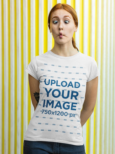 T-Shirt Mockup of a Woman Making a Funny Face in Front of a Striped Wall