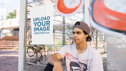 Poster Video Mockup Glued to a Bus Stop With Graffities While Near a Young Skater Guy Sitting a13899