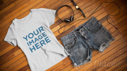 T-Shirt Video Mockup with a Watch and Shorts Outfit Lying on a Wooden Table