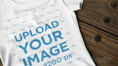 Woman's Round Neck T-Shirt Video Mockup on a Wooden Table