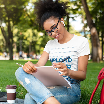 T-Shirt Mockup Featuring Happy Woman Writing Notes