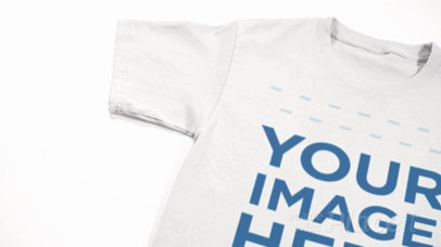 Closeup T-Shirt Video Mockup of a Round Neck Tee Lying on a White Surface