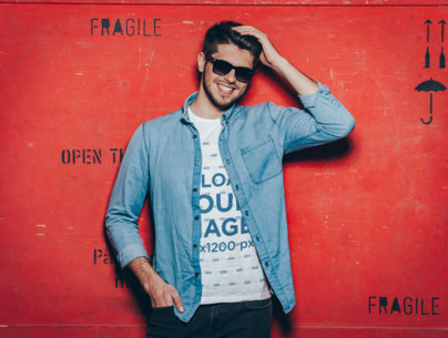 Heathered T-Shirt Mockup Featuring a  Stylish Man Posing Against a Red Background