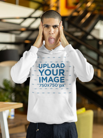 Pullover Hoodie Mockup Featuring a Man Doing a Funny Face with His Tongue Out