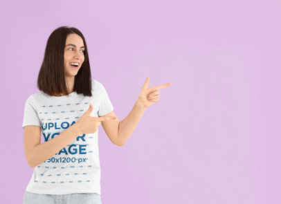 T-Shirt Mockup of a Woman Pointing with a Finger Guns-Style Hand Gesture