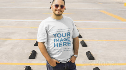 Young Man Styling a Plus Size T-Shirt Video with Sunglasses in a Parking Lot a12463