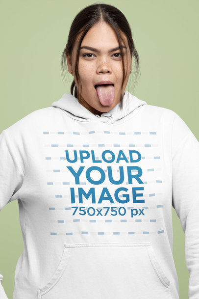Mockup of a Woman Sticking Her Tongue Out While Wearing a Hoodie