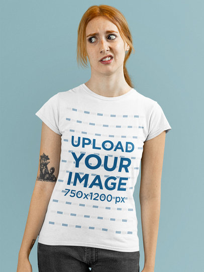 T-Shirt Mockup of a Young Tattooed Woman Making a Disgusted Expression
