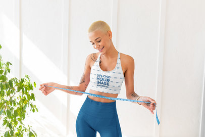 Sports Bra Mockup Featuring a Young Short-Haired Woman Measuring Her Waist