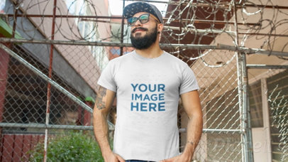 Hipster Guy with a Beard Wearing a Round Neck T-Shirt Video Mockup and a Snapback Hat 