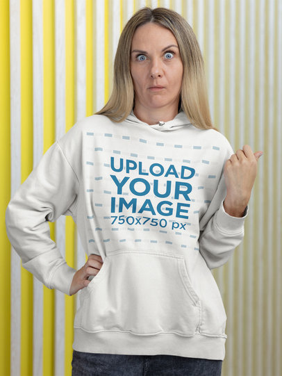 Mockup of a Woman Wearing a Hoodie While Making an Expression of Shock