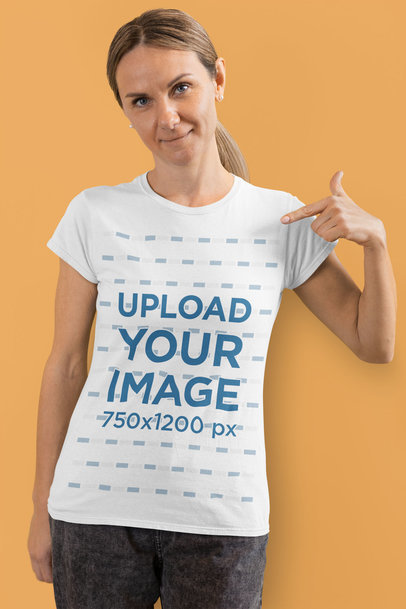 Mockup Featuring a Woman Pointing at Her Basic T-Shirt at a Studio