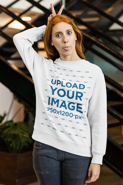 Sweatshirt Mockup of a Red-Haired Woman Making a Funny Pose to the Camera m22401