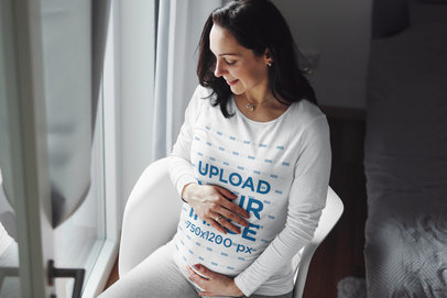 Long Sleeve Tee Mockup of a Joyful Pregnant Woman Sitting by a Window