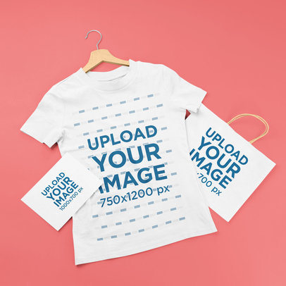 Mockup of a T-Shirt on a Hanger Placed Next to a Greeting Card and a Shopping Bag m21169-r-el2
