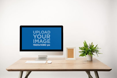 Mockup of an iMac in a Medium Wooden Desk 